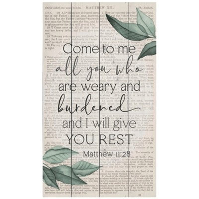 Wooden wall art panel featuring the Bible verse Matthew 11:28 "Come to me all you who are weary and burdened, and I will give you rest." Text is surrounded by a simple botanical design. Panel measures 24 inches wide by 14 inches tall.