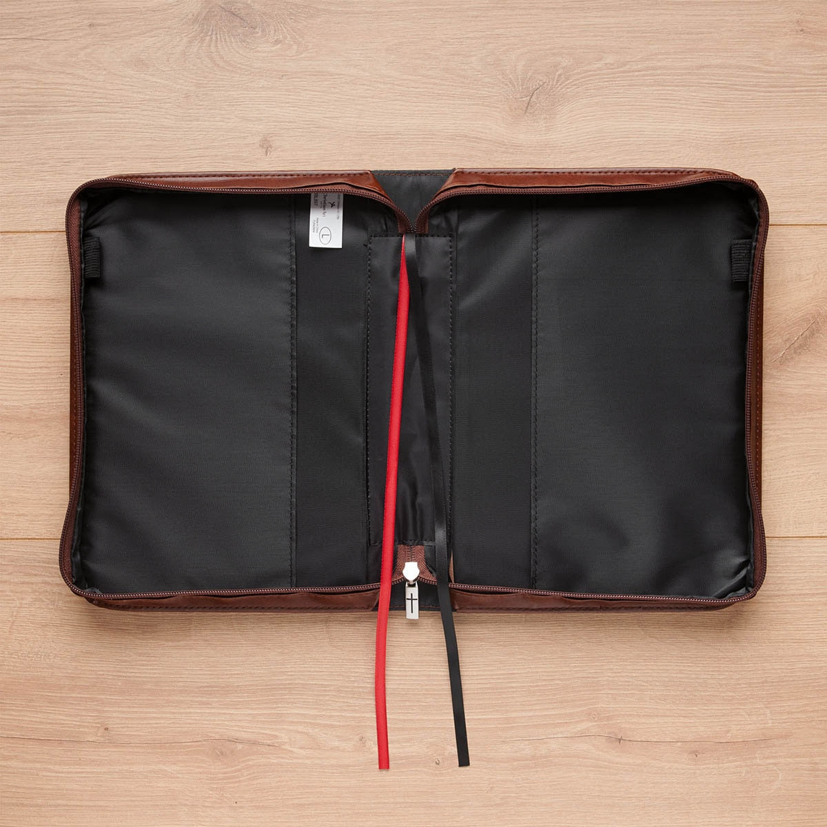 Open honey-brown lion Bible cover with pen loops and red and black ribbon markers
