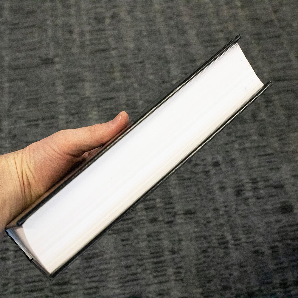 Side view of the NKJV Pew Bible, Large Print held in one hand to show its thickness.