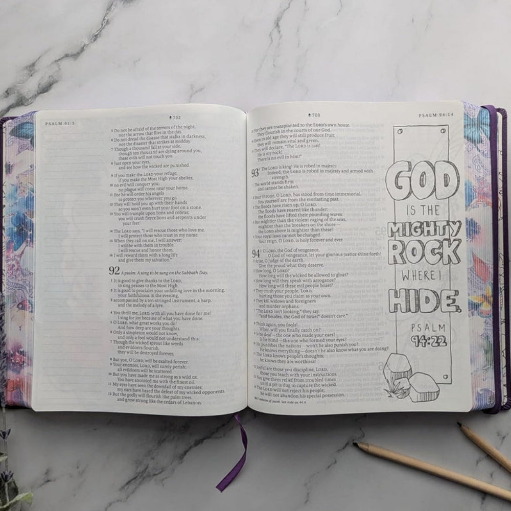 Open NLT Inspire Praise Bible showing Scripture beside a coloring illustration and wide journaling space.